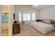 Bright bedroom features bay windows, neutral walls, and an attached bathroom at 103 S Birdie Way, Casa Grande, AZ 85194