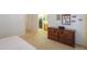 Bright bedroom featuring neutral walls, a dresser, and an ensuite bathroom for added convenience at 103 S Birdie Way, Casa Grande, AZ 85194