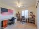 Well-lit bedroom with two desks, shelving, and large window at 103 S Birdie Way, Casa Grande, AZ 85194