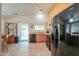 Well-lit kitchen with stainless steel appliances, tile flooring, and a sliding door to the backyard at 103 S Birdie Way, Casa Grande, AZ 85194