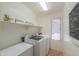 A laundry room featuring a washer, dryer, and freezer at 103 S Birdie Way, Casa Grande, AZ 85194