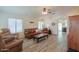 Spacious living room with wood flooring, ceiling fan, and plenty of natural light at 103 S Birdie Way, Casa Grande, AZ 85194