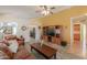 Cozy living room featuring a ceiling fan, wood flooring, and access to the kitchen at 103 S Birdie Way, Casa Grande, AZ 85194