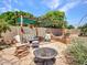Charming outdoor space featuring a stone patio, pergola, and seating area at 10501 W Wilshire Dr, Avondale, AZ 85392