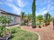 Picture-perfect backyard, showcasing lush landscaping and the side of the house at 10501 W Wilshire Dr, Avondale, AZ 85392