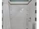Bright bathroom with neutral-colored shower, storage, and shower head at 10501 W Wilshire Dr, Avondale, AZ 85392