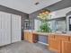 Bathroom features dual sinks, wood cabinets, and a decorative hanging plant at 10501 W Wilshire Dr, Avondale, AZ 85392