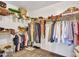 Walk-in closet with built-in shelving and racks to organize clothing and accessories at 10501 W Wilshire Dr, Avondale, AZ 85392