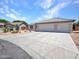 Attractive house showcasing an oversized driveway, three-car garage, and desert landscaping at 10501 W Wilshire Dr, Avondale, AZ 85392