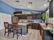 Bright kitchen with stainless steel appliances and a functional center island with seating at 10501 W Wilshire Dr, Avondale, AZ 85392