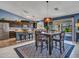 Modern kitchen with stainless appliances, dark wood cabinets, and a dining area with an area rug at 10501 W Wilshire Dr, Avondale, AZ 85392
