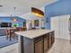 Kitchen island with seating that opens to the dining and living areas at 10501 W Wilshire Dr, Avondale, AZ 85392
