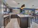 This open-concept kitchen has stainless appliances, stylish counters, and a functional center island at 10501 W Wilshire Dr, Avondale, AZ 85392