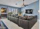 Comfortable living room featuring a spacious couch, large windows, and tile flooring at 10501 W Wilshire Dr, Avondale, AZ 85392