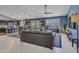 Open-concept living area with a large leather couch, tile floors, and an adjacent dining area at 10501 W Wilshire Dr, Avondale, AZ 85392