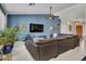 Comfortable living area with tile flooring, a ceiling fan, and an entertainment center at 10501 W Wilshire Dr, Avondale, AZ 85392