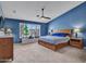 Comfortable bedroom with ceiling fan, large window, and soft carpet at 10501 W Wilshire Dr, Avondale, AZ 85392