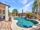 Inviting backyard featuring a lovely pool and tropical landscaping at 10501 W Wilshire Dr, Avondale, AZ 85392
