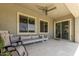 A covered patio featuring a ceiling fan and outdoor seating at 11015 E Texas Ave, Mesa, AZ 85212