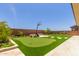 Well landscaped backyard with putting green, basketball hoop, and stone pavers at 11015 E Texas Ave, Mesa, AZ 85212