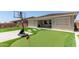 A backyard boasting artificial turf, putting green, and basketball hoop at 11015 E Texas Ave, Mesa, AZ 85212