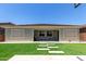 A backyard featuring artificial turf, stepping stones, and a putting green at 11015 E Texas Ave, Mesa, AZ 85212