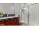 Bathroom features a vanity with a modern sink and glass shower at 11015 E Texas Ave, Mesa, AZ 85212