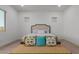 Bedroom with decoratively pillowed bench at the foot of the bed and white walls at 11015 E Texas Ave, Mesa, AZ 85212