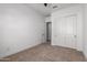This bedroom features neutral carpet, white walls and a sliding door closet at 11015 E Texas Ave, Mesa, AZ 85212