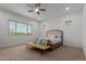 Bright bedroom featuring a ceiling fan, natural light, and neutral color palette at 11015 E Texas Ave, Mesa, AZ 85212