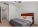 Cozy bedroom features neutral tones, a ceiling fan, and an adjacent closet at 11015 E Texas Ave, Mesa, AZ 85212