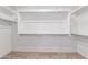 Empty walk-in closet with carpeted floor and ample shelving and hanging space at 11015 E Texas Ave, Mesa, AZ 85212