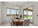 Bright dining room with a contemporary light fixture, backyard view, and stylish upholstered chairs at 11015 E Texas Ave, Mesa, AZ 85212