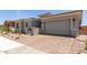 Single-story home features a well-maintained front yard, two-car garage, and a secure gated entryway at 11015 E Texas Ave, Mesa, AZ 85212