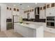 Modern kitchen featuring white cabinetry, stainless steel appliances, and a stylish backsplash at 11015 E Texas Ave, Mesa, AZ 85212