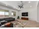 Cozy living room featuring a large window for natural light, comfortable sectional sofa, and ceiling fan at 11015 E Texas Ave, Mesa, AZ 85212
