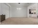 Open-concept living space with neutral color palette, recessed lighting, and smooth carpet flooring at 11015 E Texas Ave, Mesa, AZ 85212