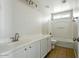 Modern bathroom with double vanity, tiled floor, toilet, and a bathtub-shower combination at 118 N 223Rd Ave, Buckeye, AZ 85326