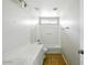 Bright bathroom features a large mirror, tiled floor, and bathtub-shower combo at 118 N 223Rd Ave, Buckeye, AZ 85326