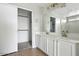 Bright bathroom featuring a double vanity, tile floor, and a closet with sliding doors at 118 N 223Rd Ave, Buckeye, AZ 85326