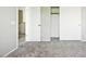 View of bedroom with neutral walls, carpet flooring, and a closet with sliding doors at 118 N 223Rd Ave, Buckeye, AZ 85326