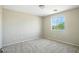 Bright bedroom featuring neutral carpet and a window that provides natural light and views at 118 N 223Rd Ave, Buckeye, AZ 85326