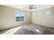Spacious bedroom with neutral carpet and a large window offering natural light and views at 118 N 223Rd Ave, Buckeye, AZ 85326