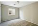 Neutral bedroom with carpeted floors and a window providing natural light at 118 N 223Rd Ave, Buckeye, AZ 85326