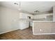 Well-lit kitchen featuring tile flooring, white cabinets, and a breakfast bar at 118 N 223Rd Ave, Buckeye, AZ 85326