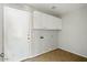 Laundry room with a white door and white cabinets at 118 N 223Rd Ave, Buckeye, AZ 85326