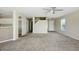 Inviting living room with open layout to kitchen, featuring neutral walls, carpet flooring, and front door access at 118 N 223Rd Ave, Buckeye, AZ 85326