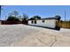 View of the home's backyard featuring gravel, fencing, and a well-maintained exterior at 132 W Orchid Ln, Chandler, AZ 85225