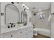 Updated bathroom features dual sinks, quartz counters, and tiled tub/shower combo at 132 W Orchid Ln, Chandler, AZ 85225