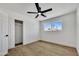 Bright bedroom features wood-look floors, a closet, and a window providing ample natural light at 132 W Orchid Ln, Chandler, AZ 85225